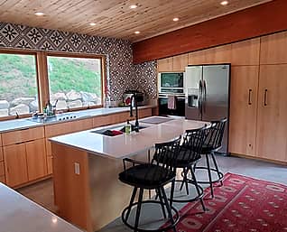 Wyman Woodworks photo of incredible maple kitchen cabinets with an angled ceiling